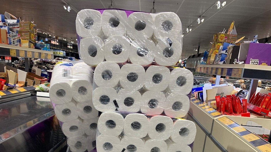 Trolley loaded with toilet paper at an Australian supermarket in coronavirus story about why everyone's buying toilet paper.