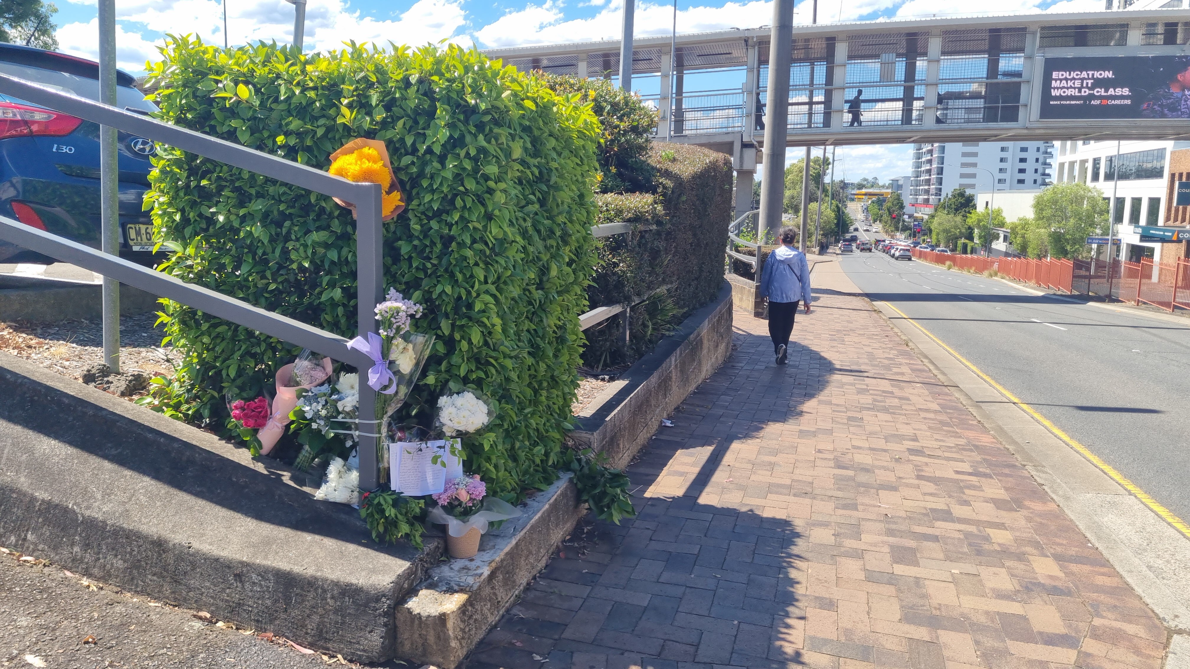 floral tributes on a fence at the site where a pregnant woman and her unborn baby were fatally struck