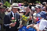 Prince Philip holds flowers and smiles as he greets the public in Perth in 2011.