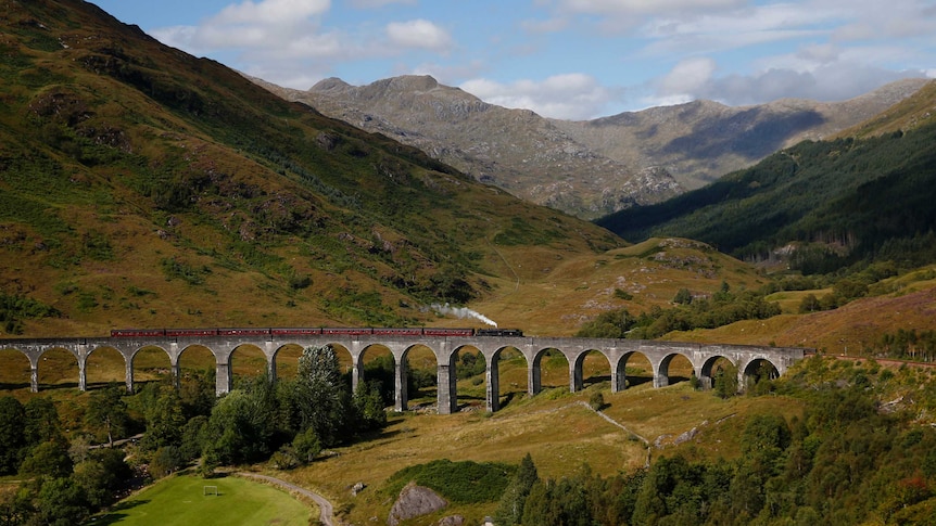 The Jacobite steam train crosses the Glenfinnan Viaduct in Scotland.