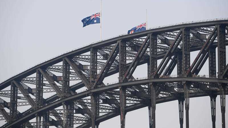 Australian flags at half-mast on the harbour bridge.
