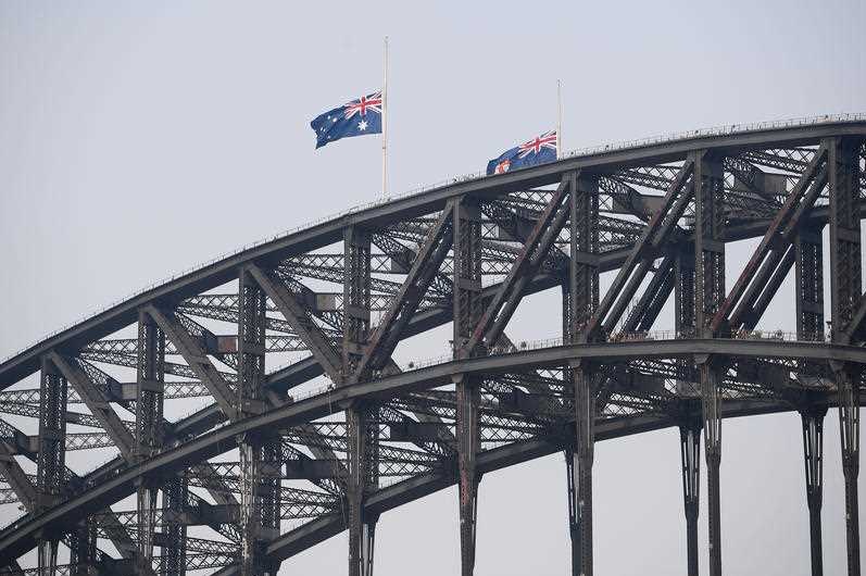 Australian flags at half-mast on the harbour bridge.