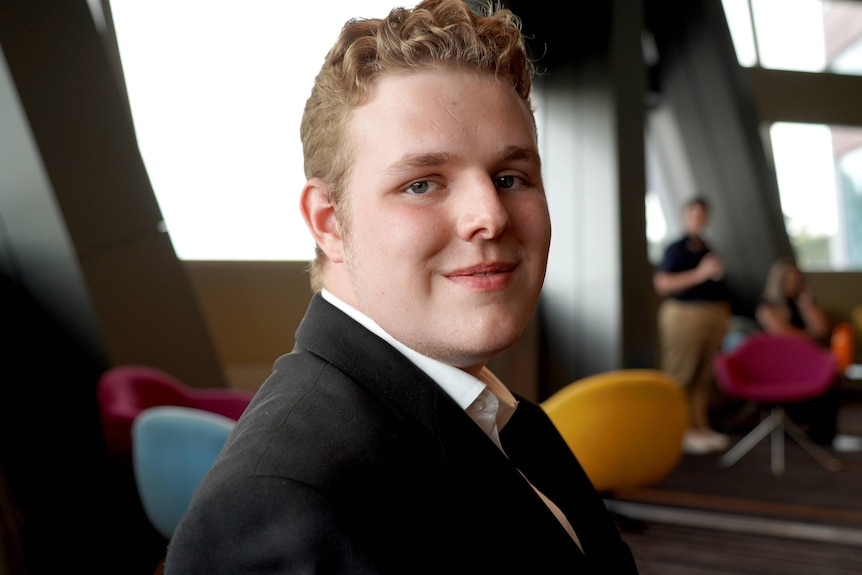 An 18-year-old student looks at the camera.