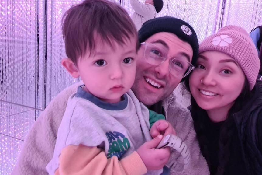 Haruna's partner Adam(middle) hugging her their son Kenji (left) and Haruna on the right. 