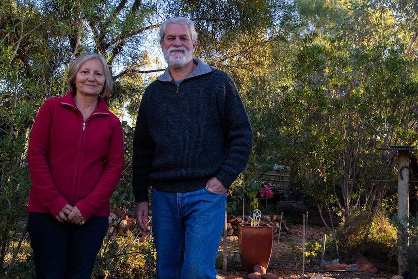 The pair stand in their garden