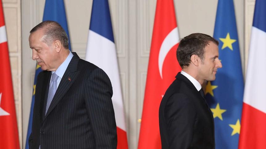 President Macron and President Erdogan are seen walking in opposite directions at a joint press conference.