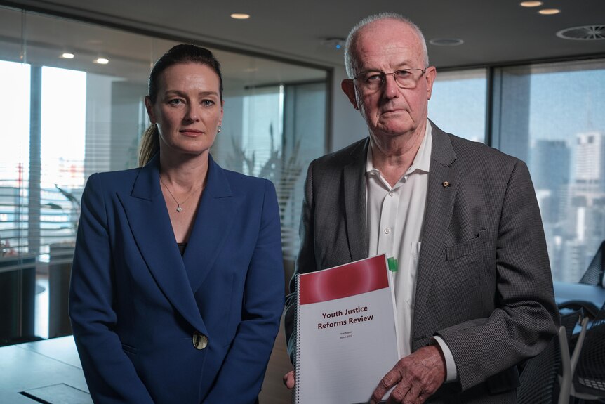 Youth Justice special adviser Bob Atkinson and Minister Leanne Linard looking serious, Mr Atkinson holding document