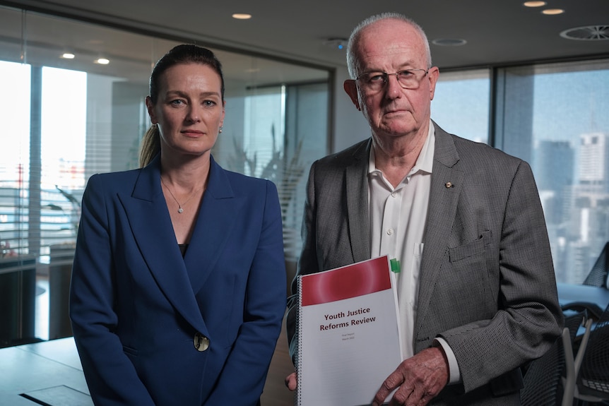 Youth Justice special adviser Bob Atkinson and Minister Leanne Linard looking serious, Mr Atkinson holding document