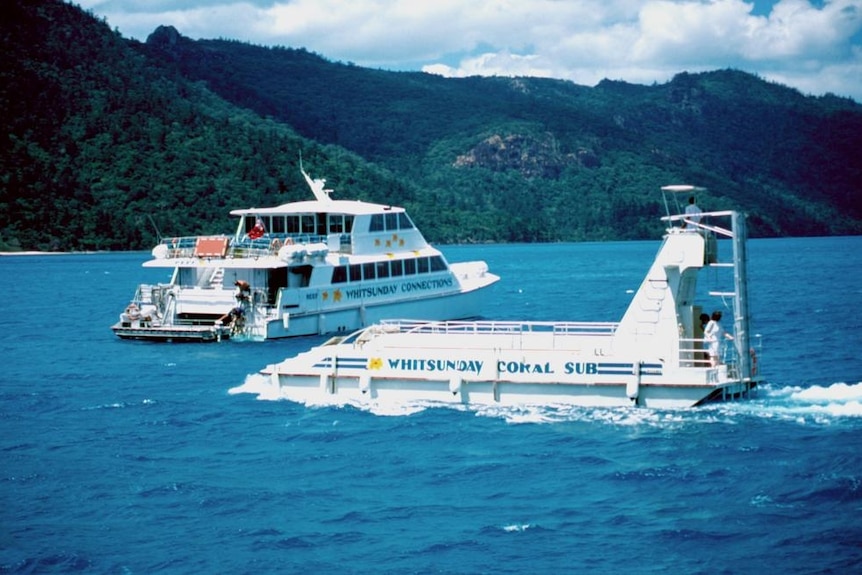 A photo from 1989 showing two boats heading to an island. 