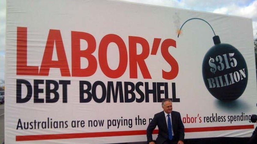 Opposition Leader Malcolm Turnbull sits on the wheel of the Coalition's 'debt truck'