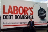 Opposition Leader Malcolm Turnbull sits on the wheel of the Coalition's 'debt truck'