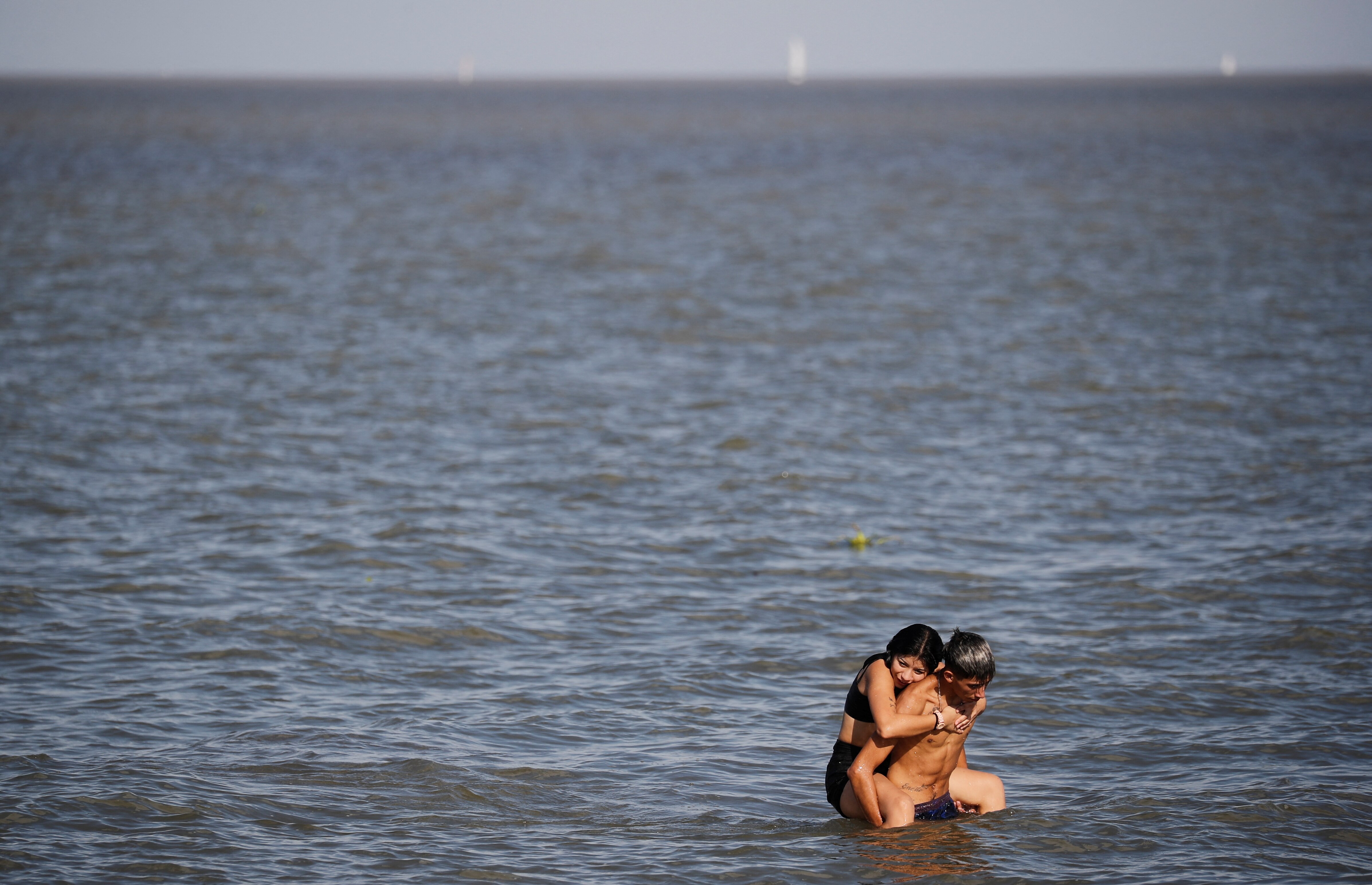 a man and woman in the water on a hot day in south america