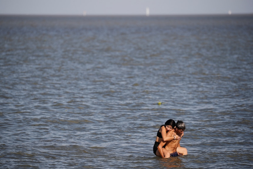 a man and woman in the water on a hot day in south america