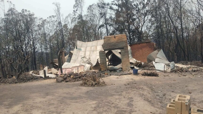 Burnt out property surrounded by blackened bushland