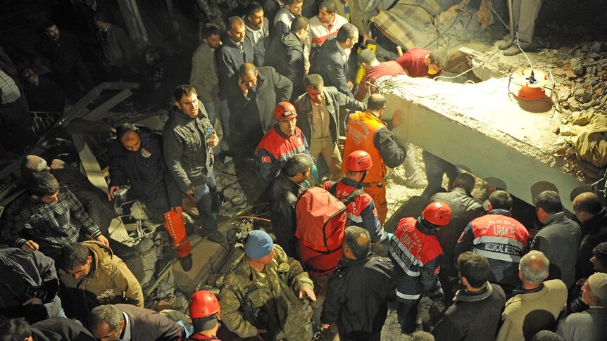 Rescue workers outside a collapsed building after an earthquake in Van, eastern Turkey on October 23, 2011.
