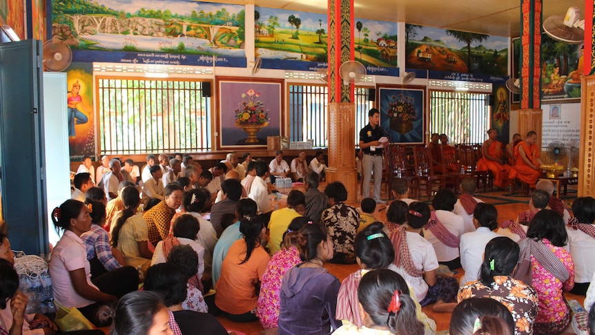 Many Cambodians gathered indoors for a community meeting