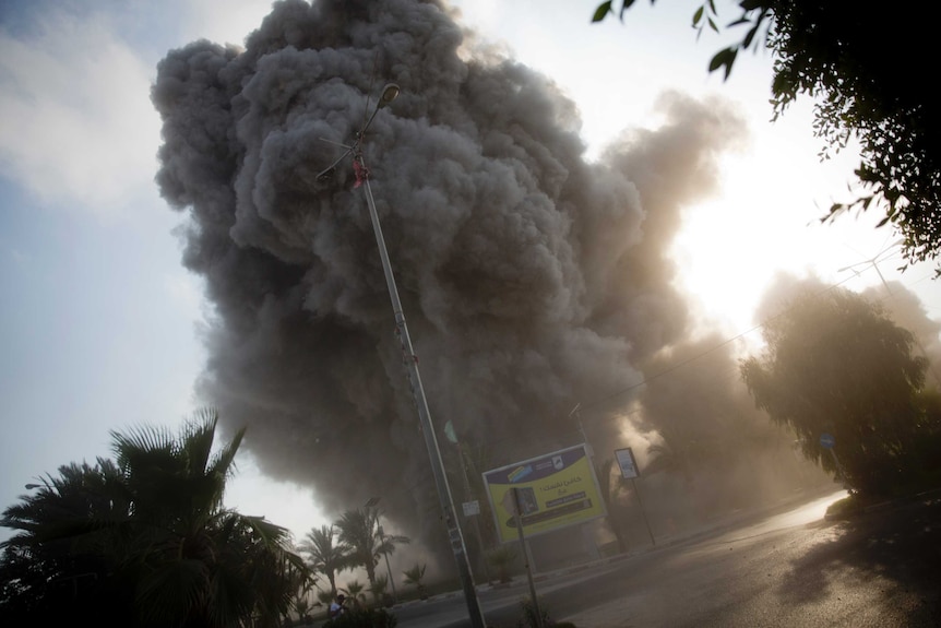 Smoke rises on the streets of Gaza city after an Israeli airstrike.