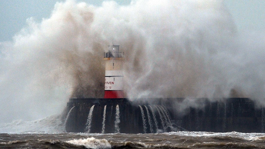 An enormous wave engulfs the Newhaven Lighthouse.