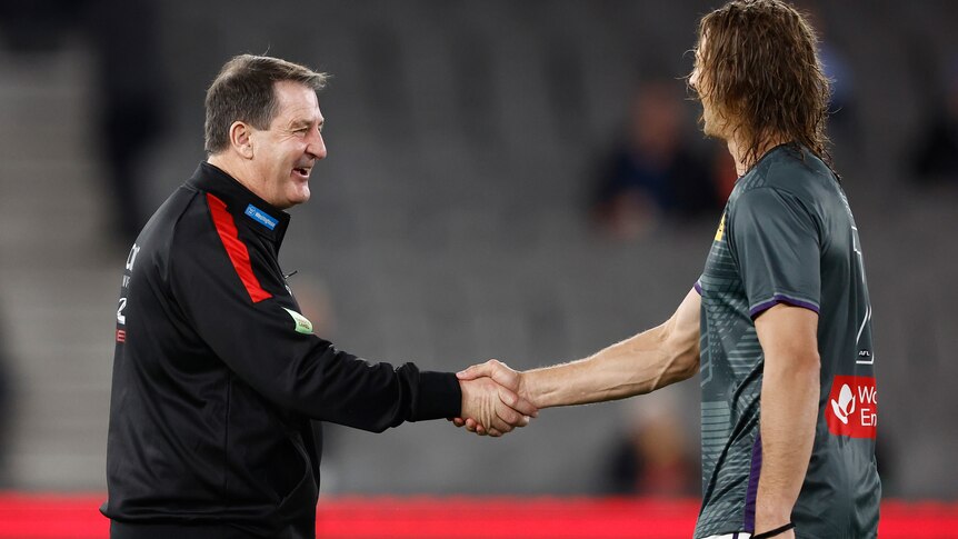 Ross Lyon and Nat Fyfe shake hands before a game