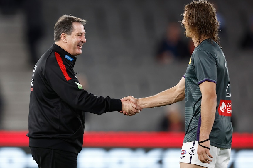 Ross Lyon and Nat Fyfe shake hands before a game