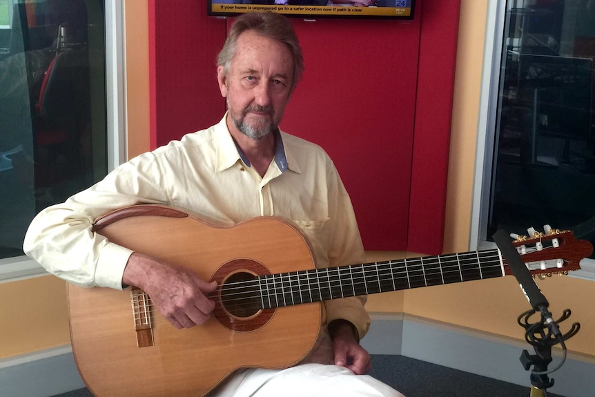 Man holding a guitar