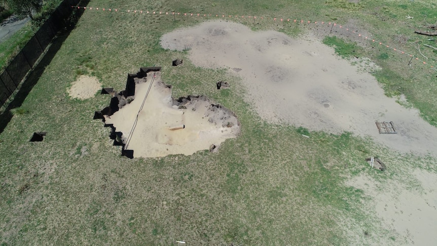 Aerial shot of land with large holes where excavation work has been conducted.