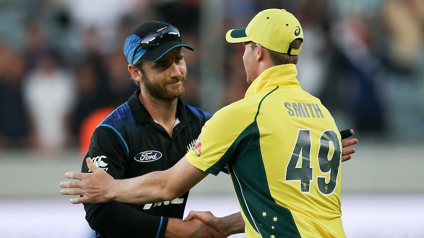 Steve Smith, right in yellow, and Kane Williamson, in black, shake hands.