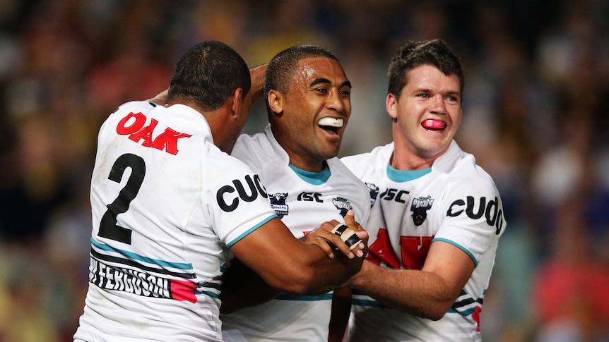 On the way to a blow-out ... Panthers centre Michael Jennings (C) celebrates with Etu Uaisele (L) and Lachlan Coote (R).
