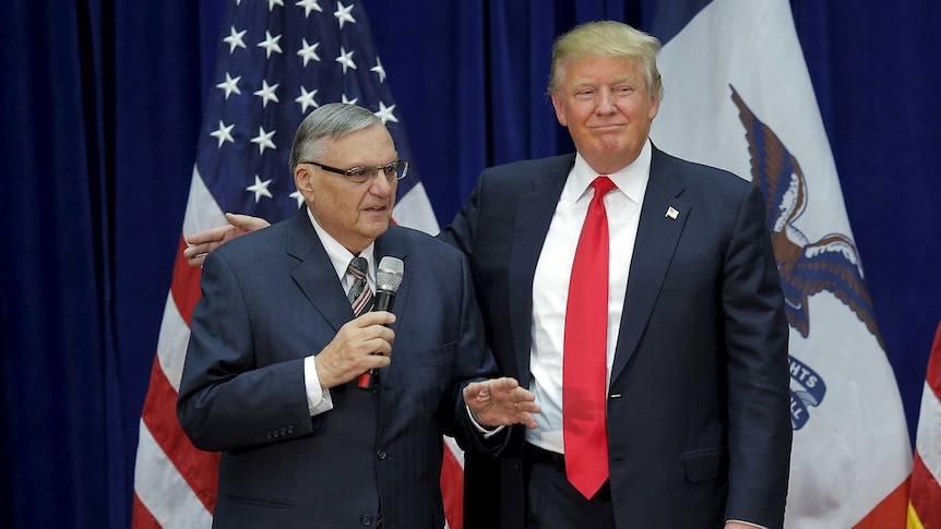 Donald Trump stands with his arm around Joe Arpaio.