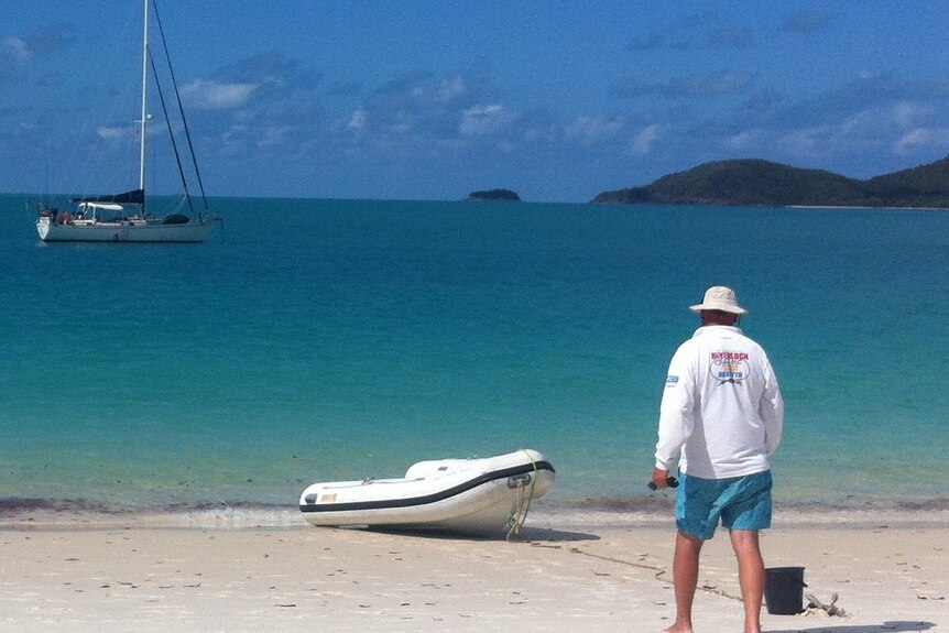 Stuart Mackley and Sally Holt ashore at Whitehaven beach, Qld. July 2021.
