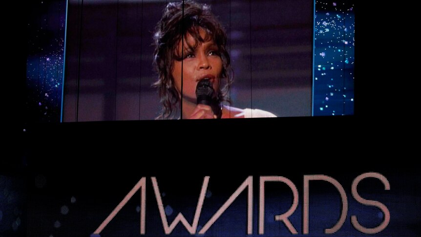 The big screen at the Grammy awards shows a 1994 performance from the late Whitney Houston