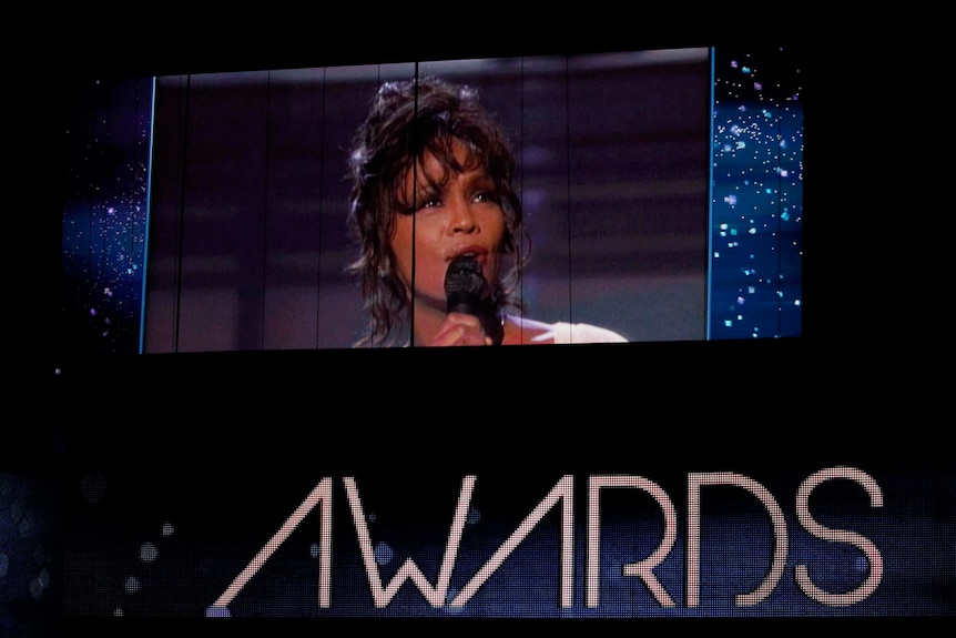 The big screen at the Grammy awards shows a 1994 performance from the late Whitney Houston