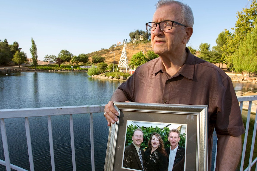 Frank Kerrigan holds a photo of his children