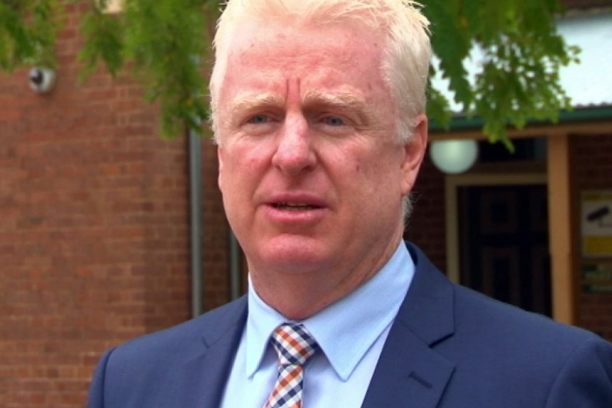 A man wearing a suit and tie