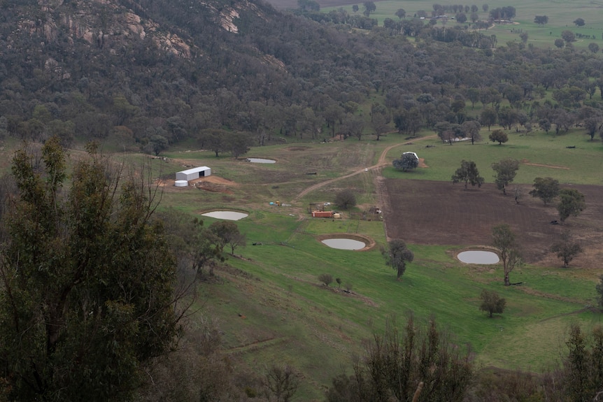 an aerial view of sheds, dams and cattle yards. 