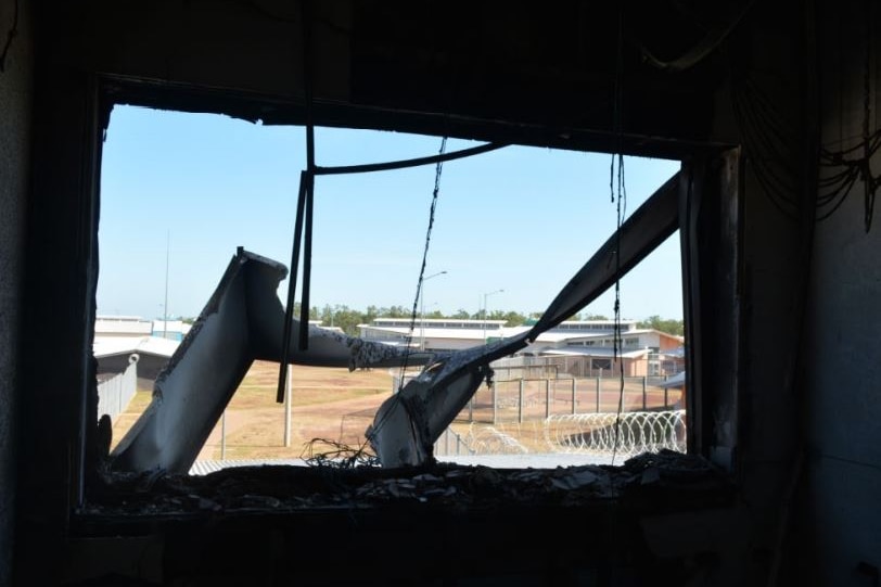 Debris outside an office window partially blocks the view overlooking the exterior of the jail.