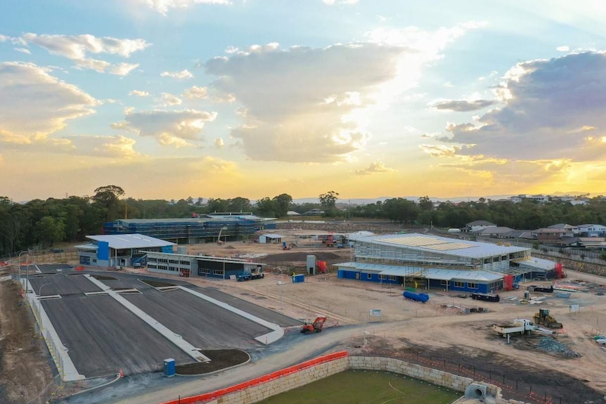 Aerial shot of a school being constructed, with several buildings going up.