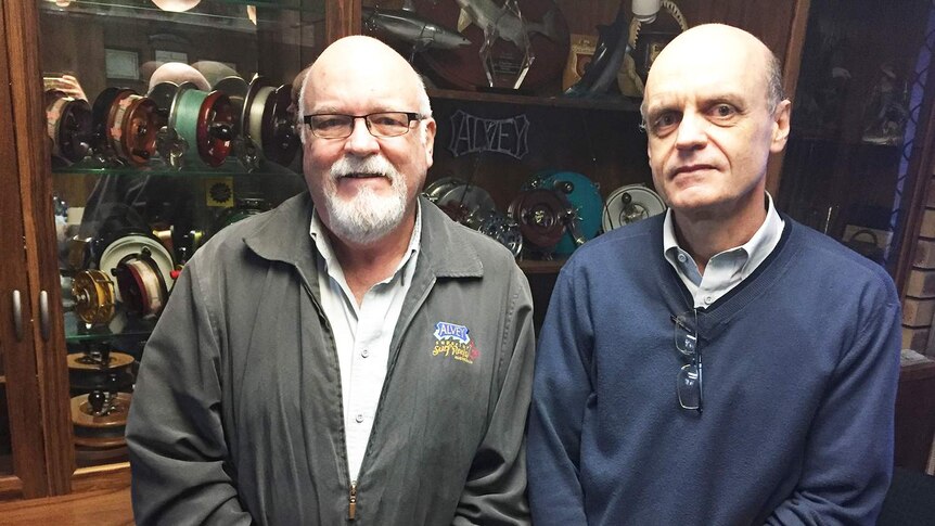 Bruce and Glenn Alvey stand together at their fishing reel factory in Ipswich.