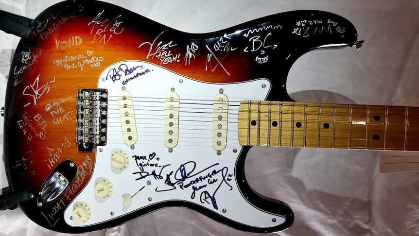 A Fender Stratocaster signed by members of Aussie bands being auctioned off for Support Act charity