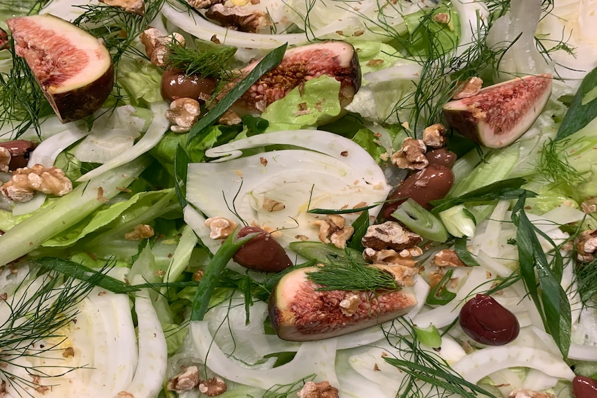 A close up of fig salad with fennel, olives and walnuts 