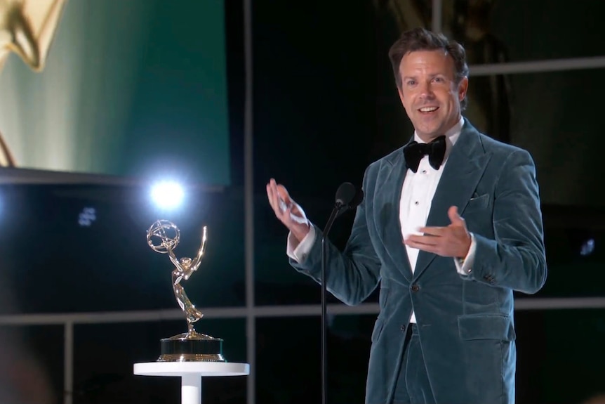 Jason Sudeikis accepts an Emmy Award.