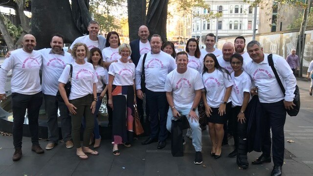 A group pf people wearing a Parkinson's disease awareness t-shirt.