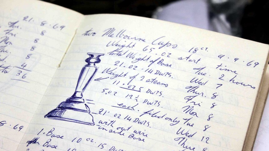 Open page of a notebook showing the length and breadth of the Melbourne Cup.