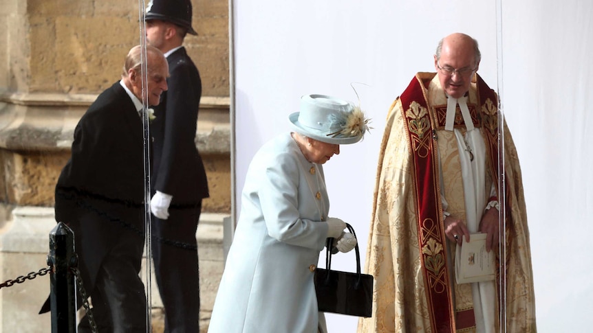 The Queen in pale blue arrives at the church with Prince Philip