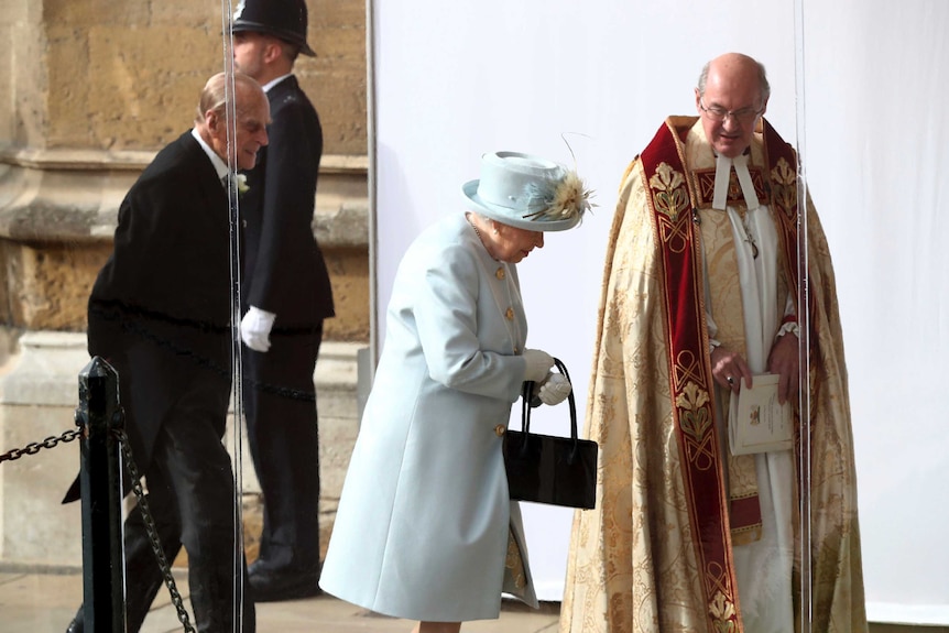 The Queen in pale blue arrives at the church with Prince Philip