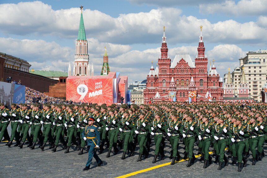 Troops march in a large organised square formation