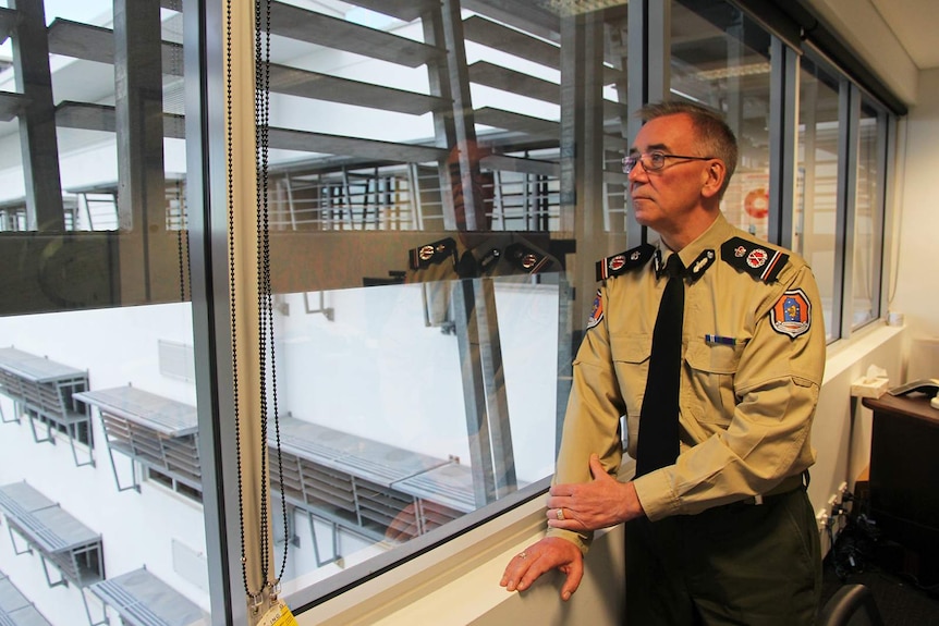 A photo of NT Corrections Commissioner Scott McNairn looking out a window in his office.