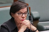 Ms McGowan sits on the backbench, with her hands locked together and a tablet computer in front of her.