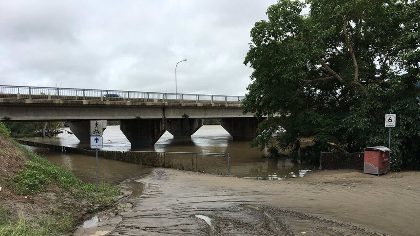 A much calmer Ross River under a bridge in Townsville as floodwaters go down.