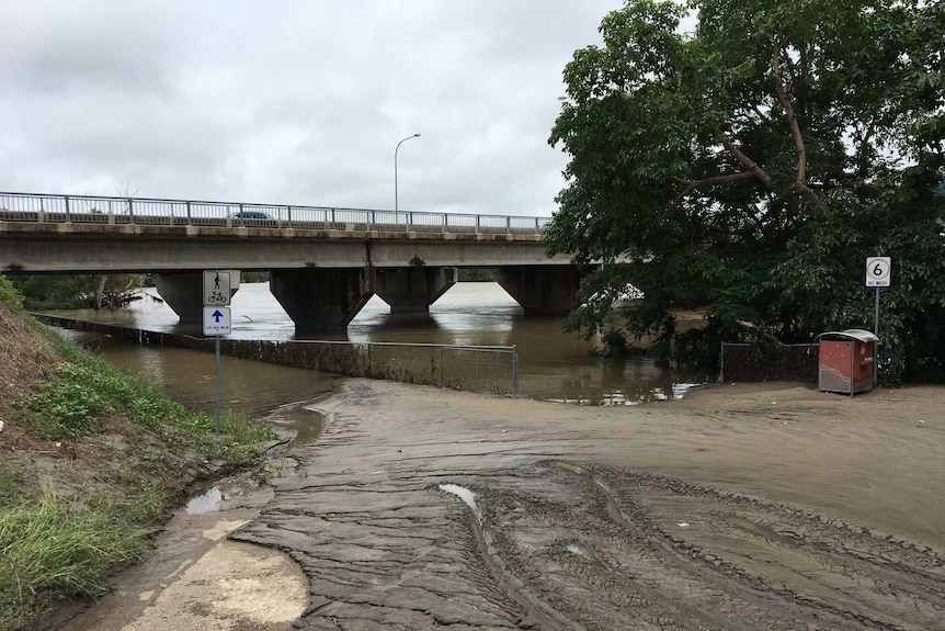 A much calmer Ross River under a bridge in Townsville as floodwaters go down.